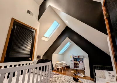 Accent walls in a playroom with vaulted ceilings painted in Sherwin Williams Black Magic